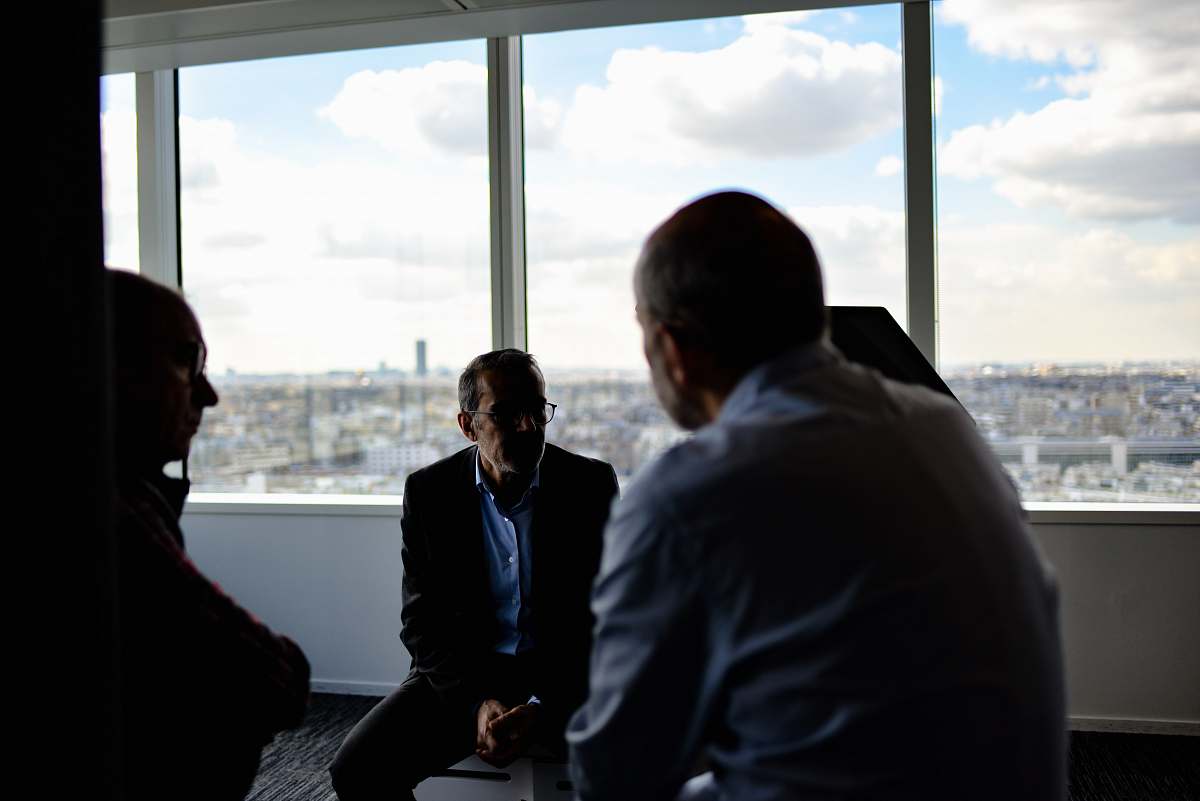 person people sitting near window having conversations sitting