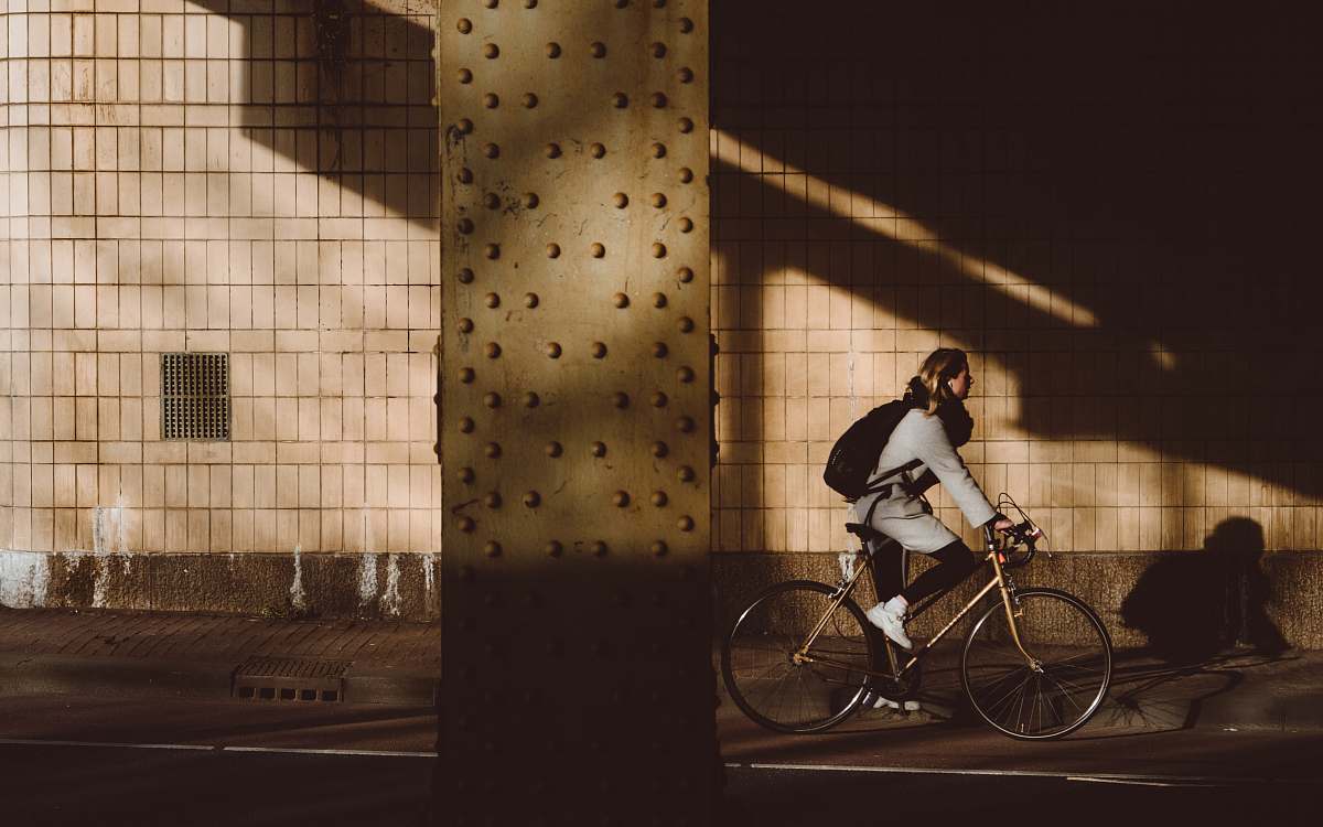 people person biking under highway bicycle
