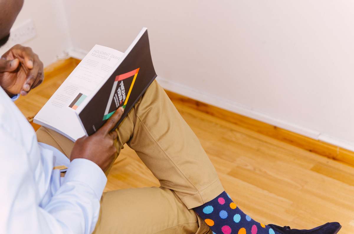 people person sitting while reading book person