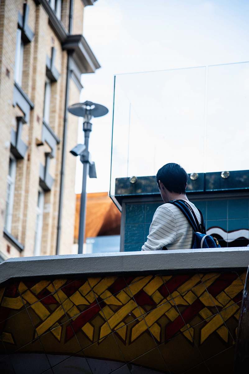 person person walking near building banister