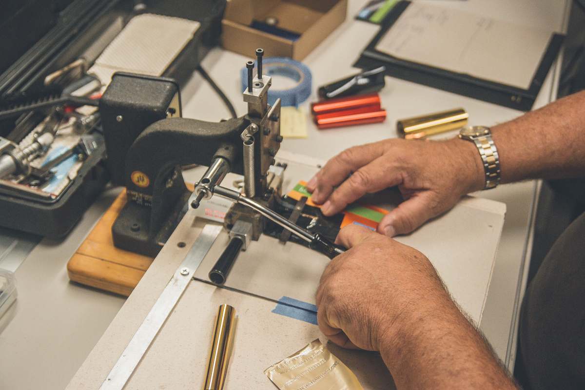 person shallow focus photo of person sewing machine