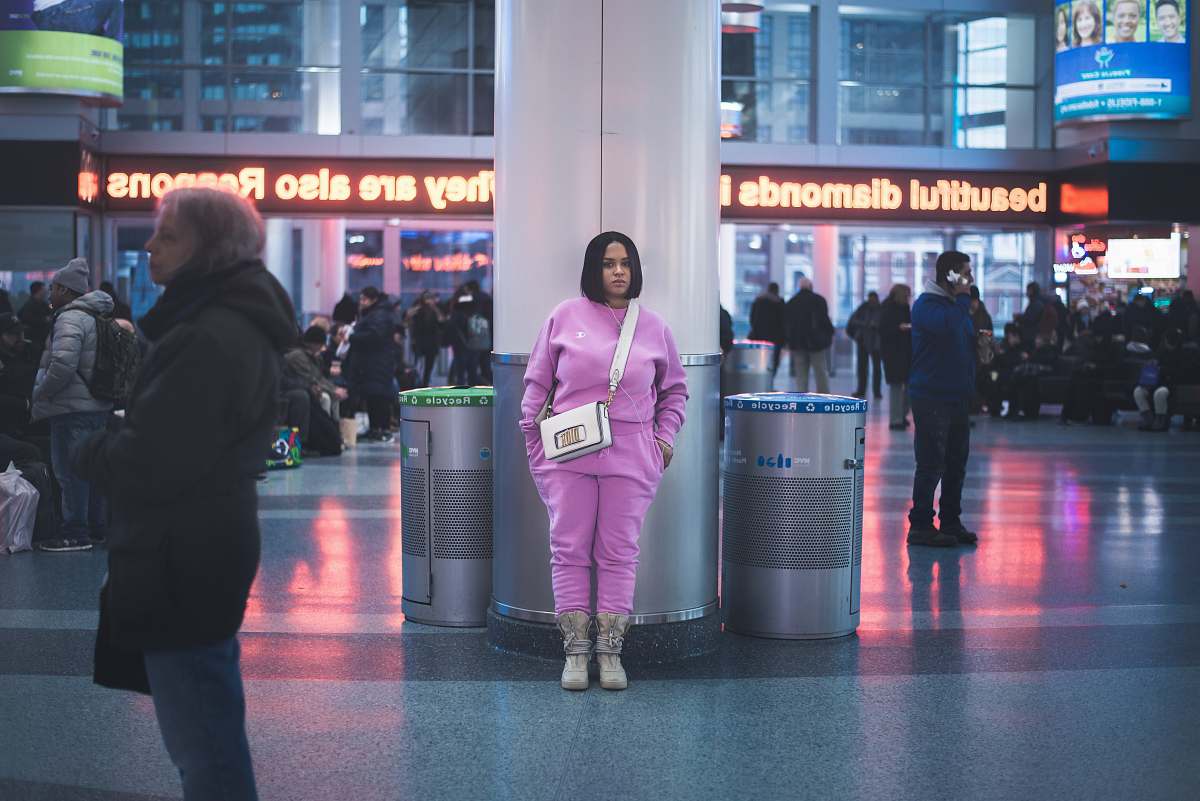 person standing woman in front of white concrete post inside building airport