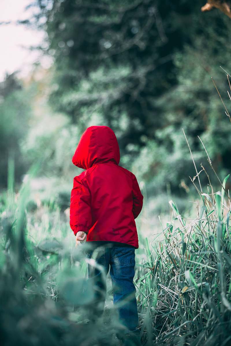 apparel toddler walking on grass field during daytime clothing