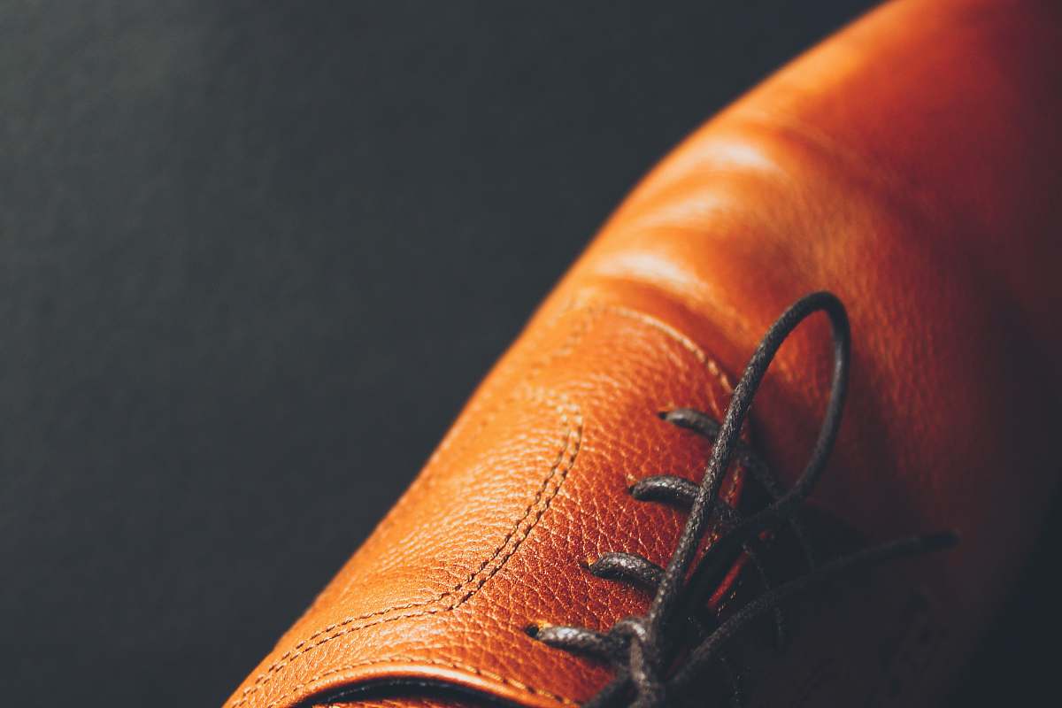 person unpaired brown leather lace-up dress shoe people