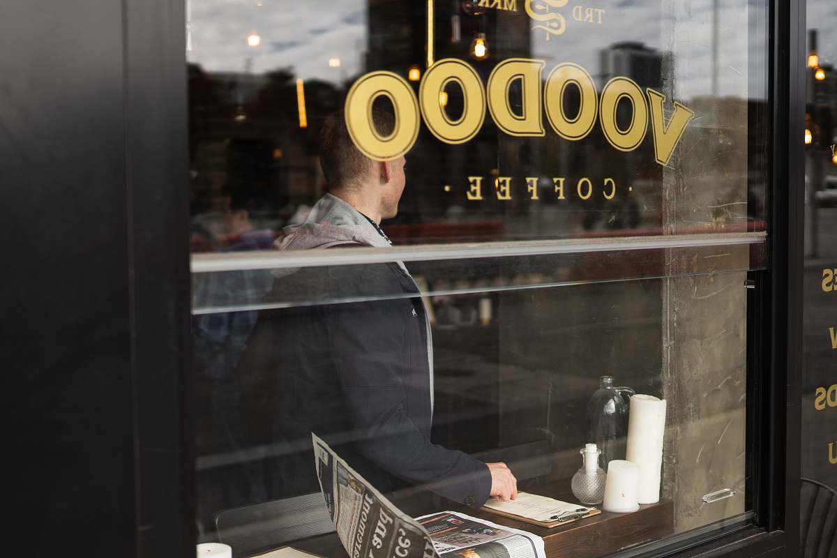 person Voodoo coffee sticker in glass cafe