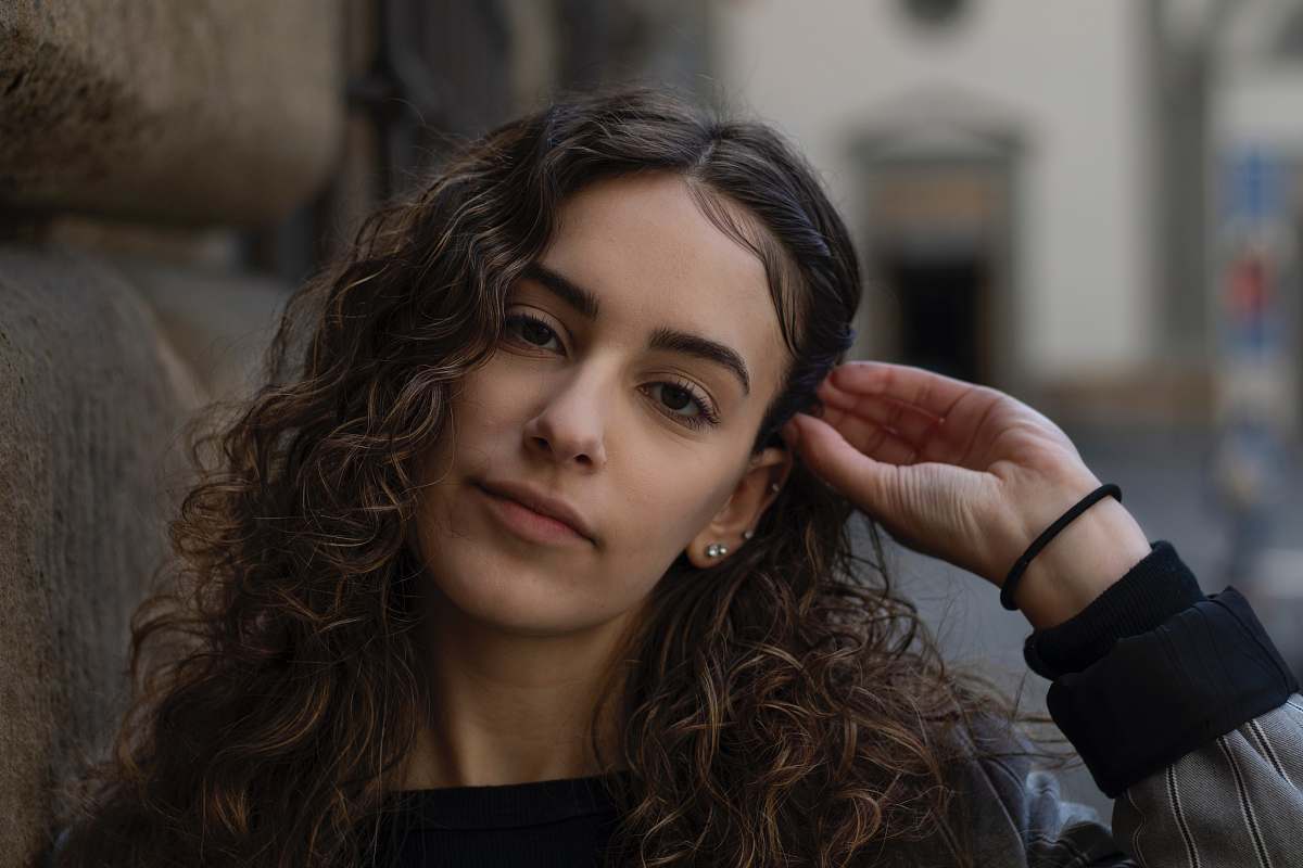 person woman fixing hair florence