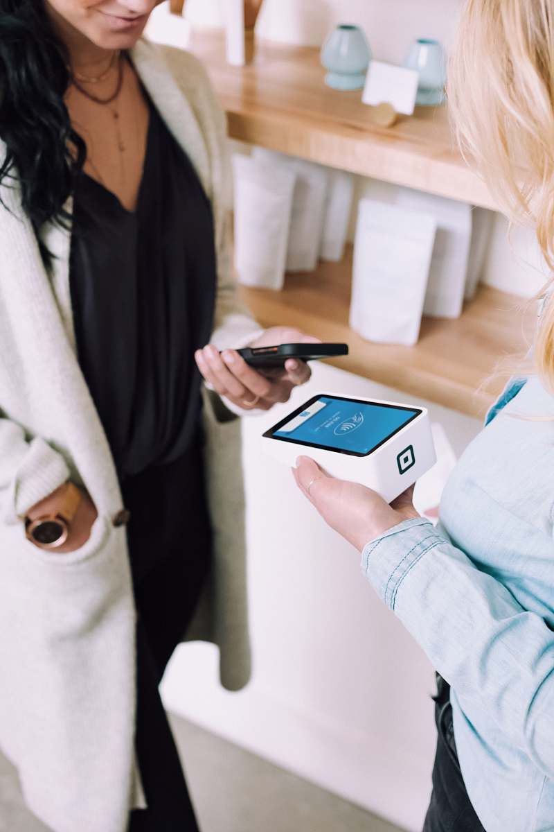 person woman holding white box pay