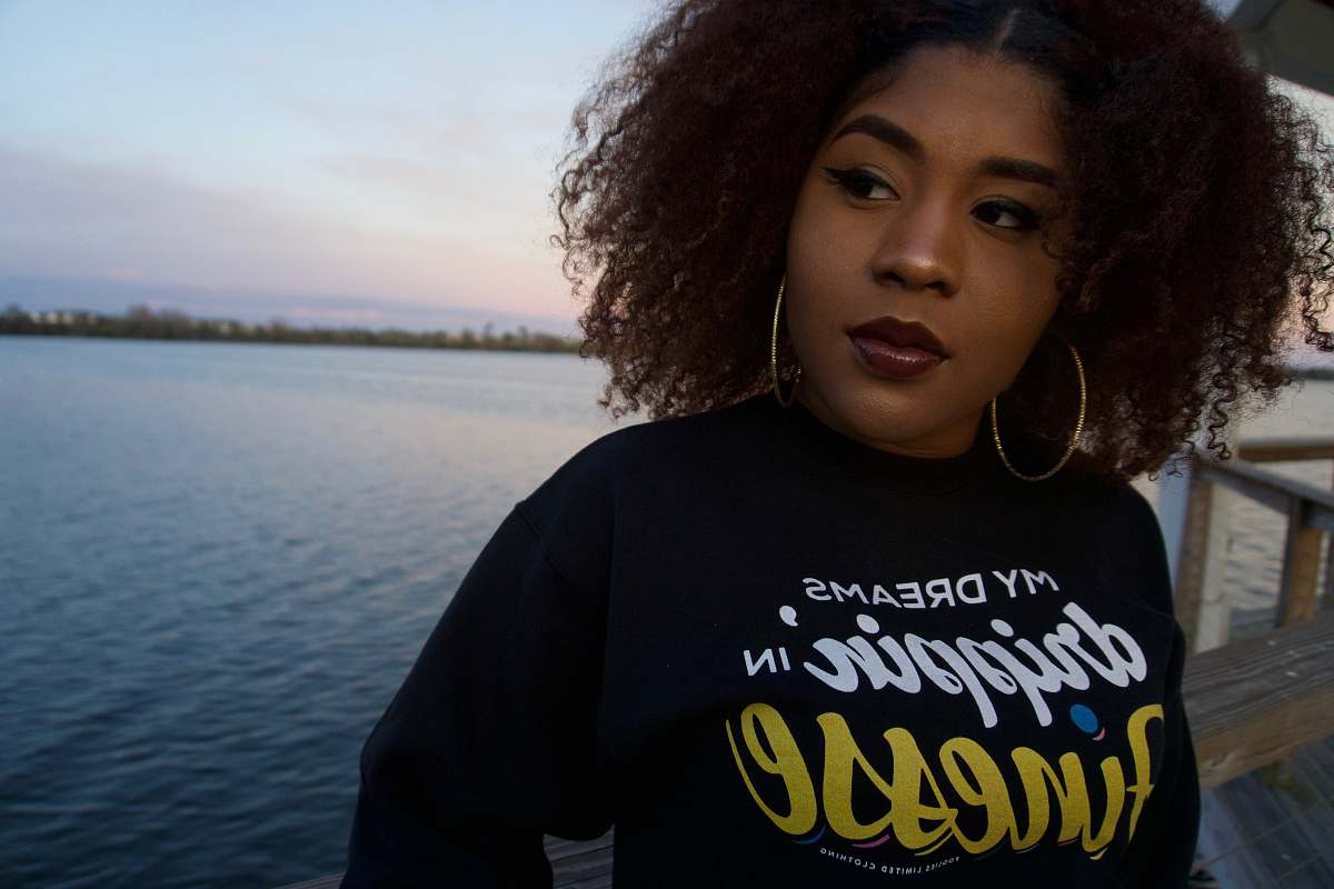 person woman in black shirt near body of water apparel