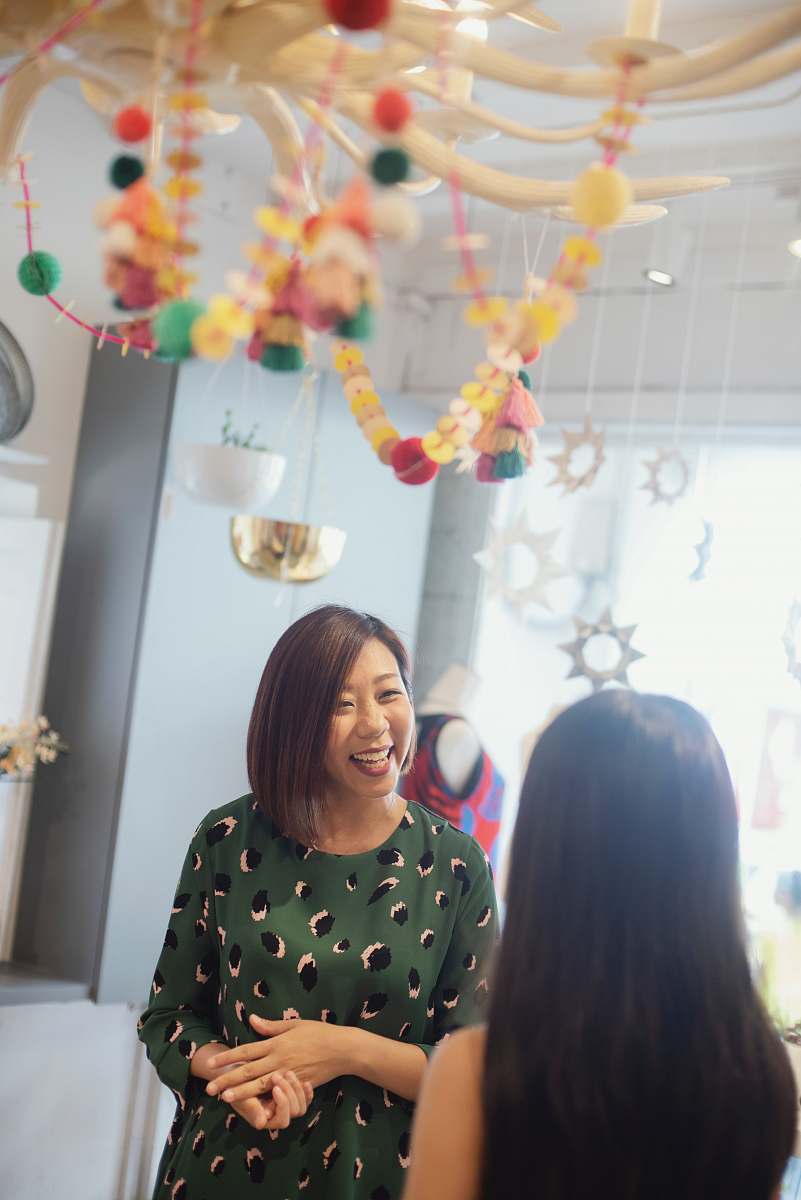 person woman smiling at another woman clothing