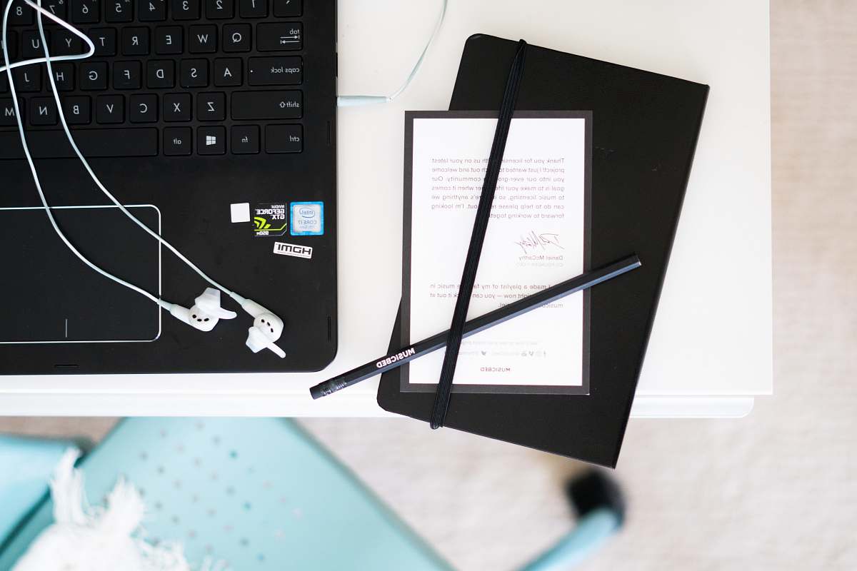 laptop black pens beside laptop computer placed on table flatlay