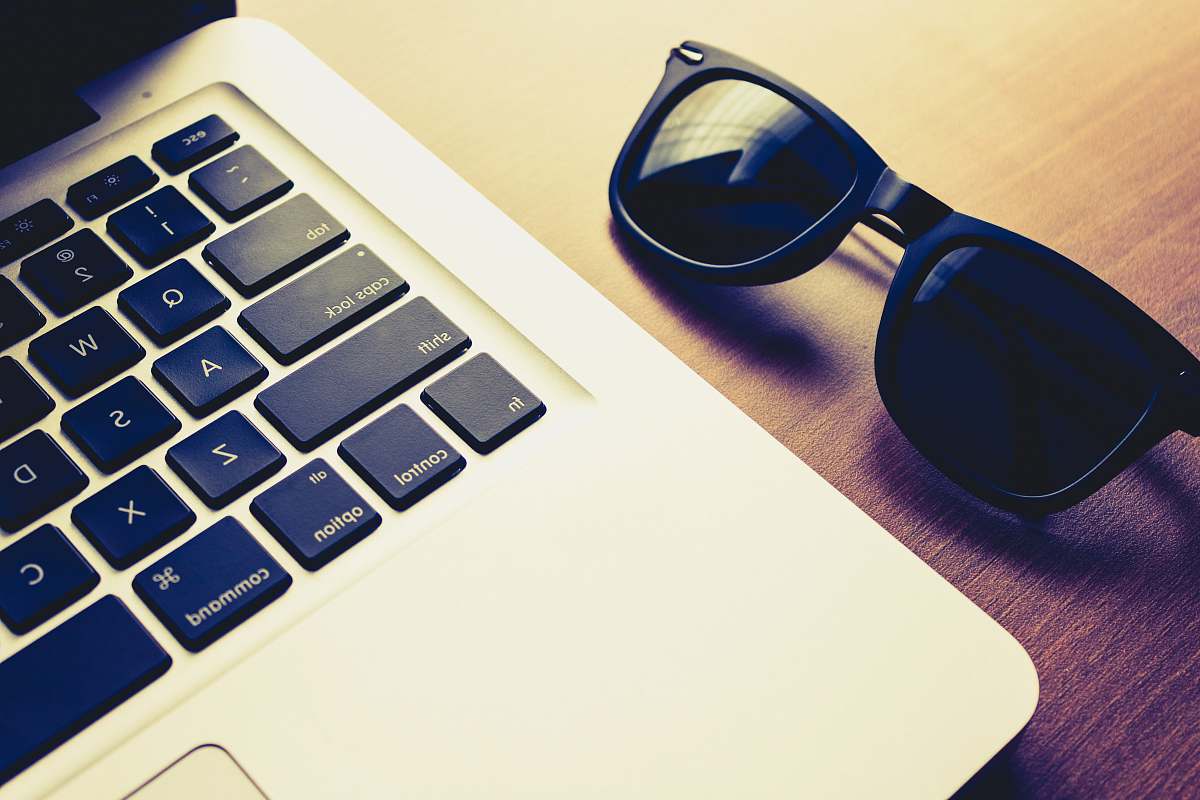 hardware MacBook Pro beside sunglasses sunglasses