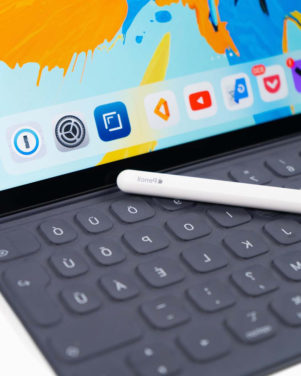 electronics white pencil stylus on grey laptop hardware