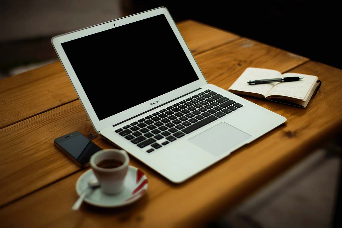 computer MacBook Air on brown wooden table coffee