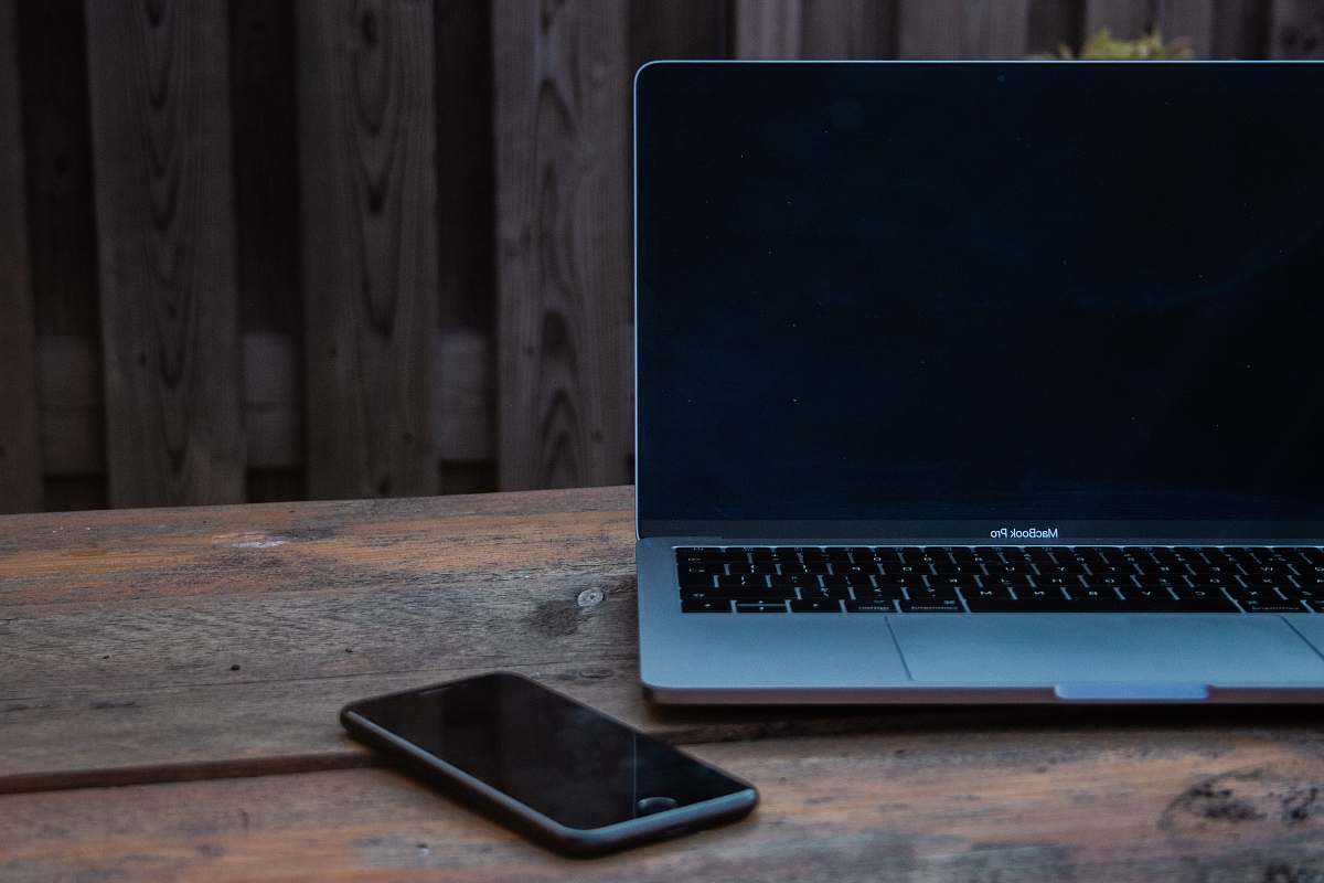 computer MacBook Pro beside space gray iPhone electronics