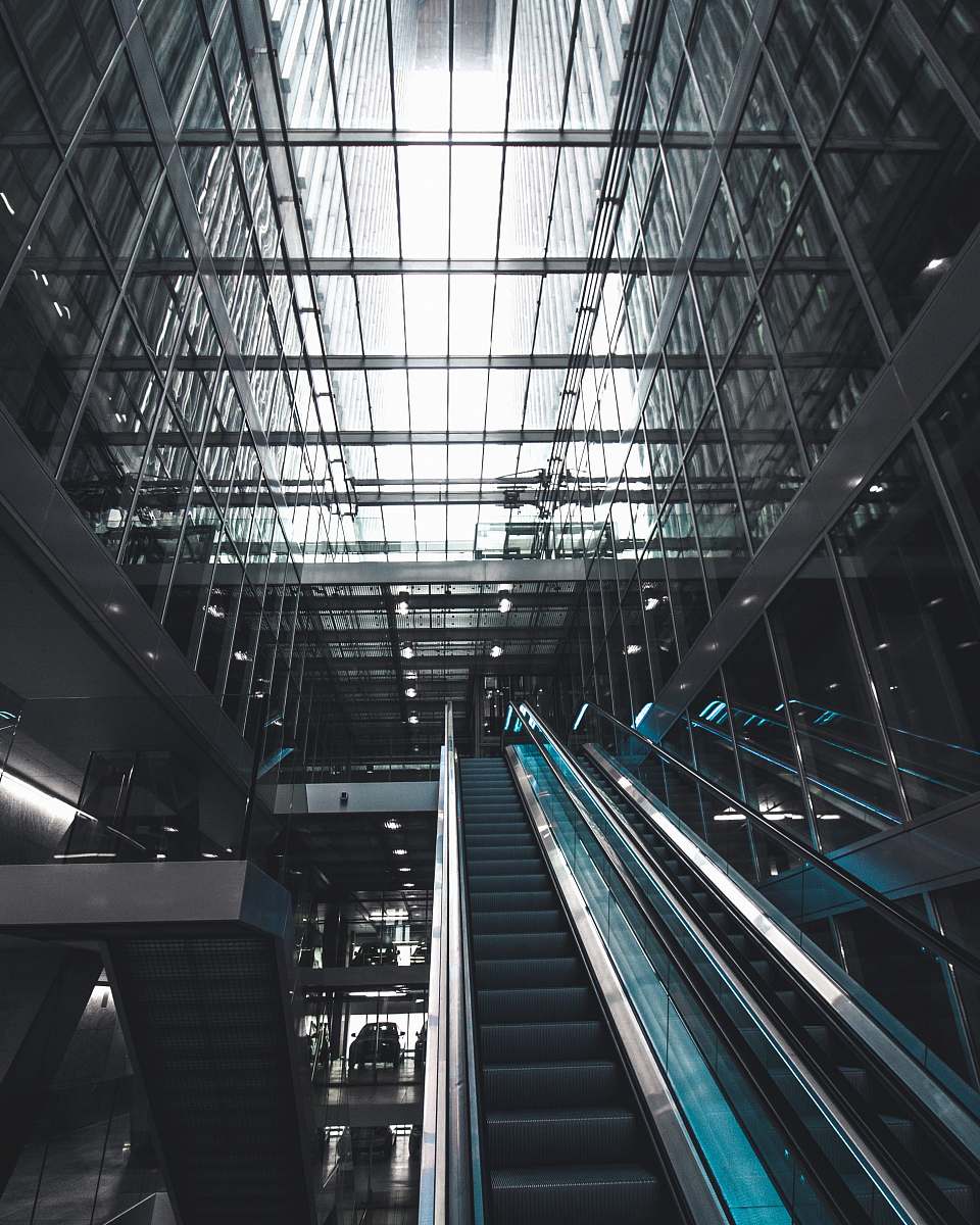 building black escalator inside glass building rotterdam