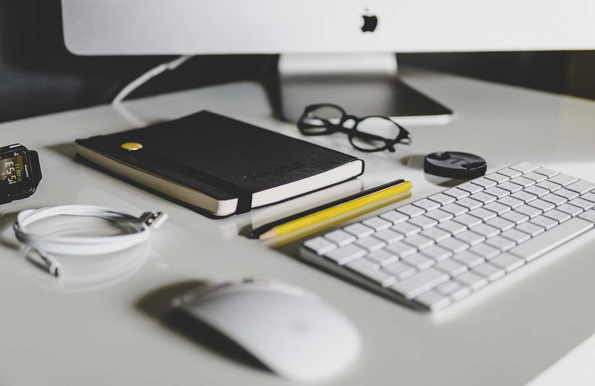desk Apple Magic Keyboard and Apple Magic Mouse on white table workspace