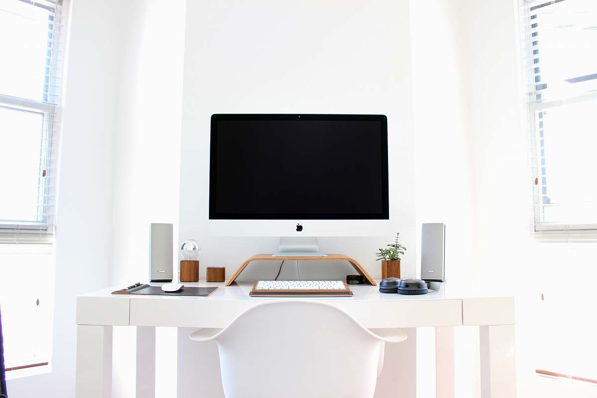 computer iMac on top of table desk