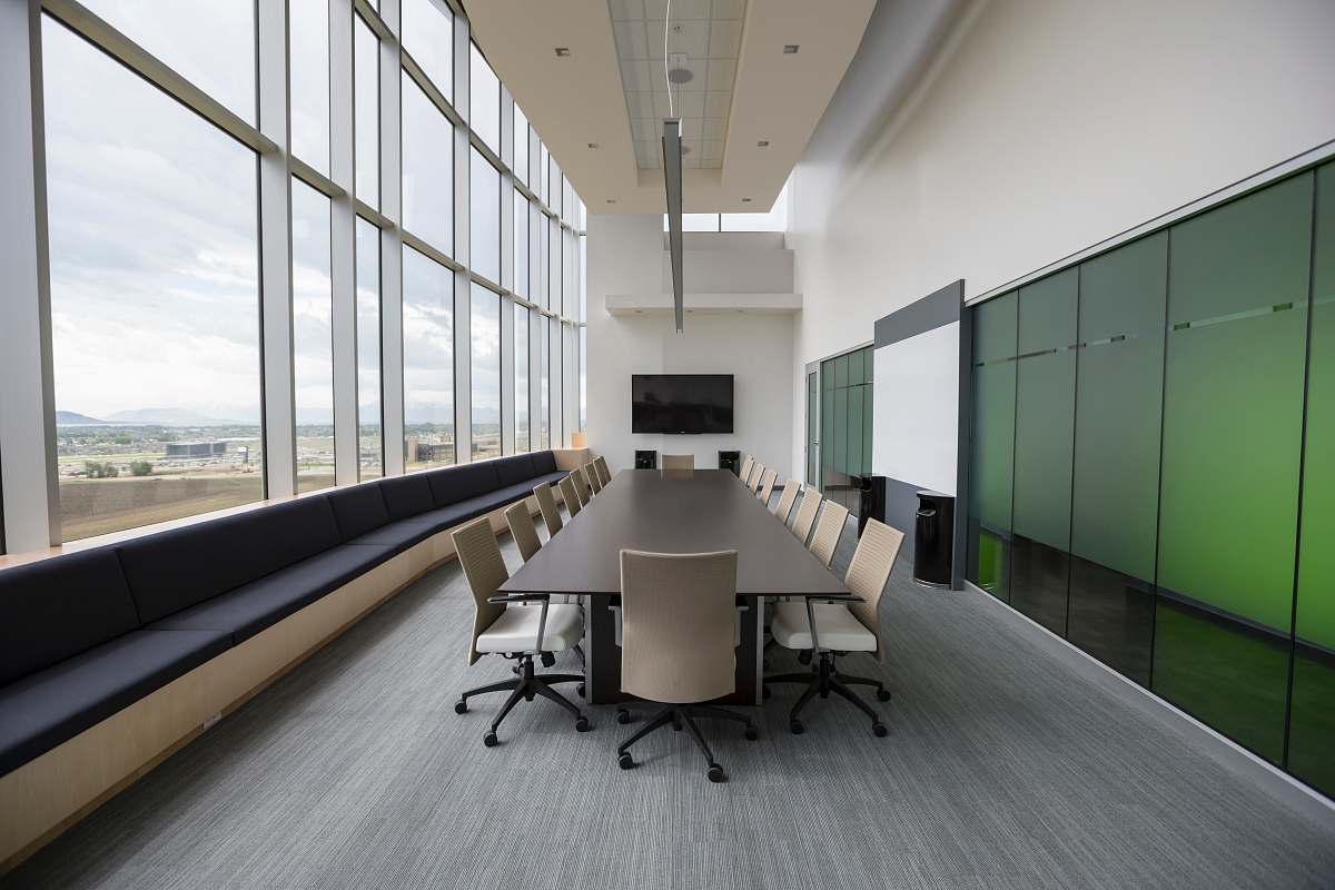 room rectangular brown wooden table with chair lot inside building meeting room