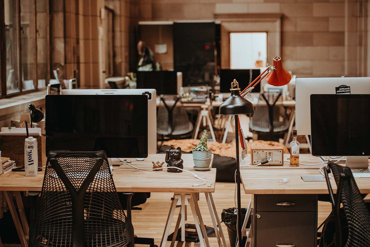 desk turned off flat screen monitors on top of beige desks restaurant