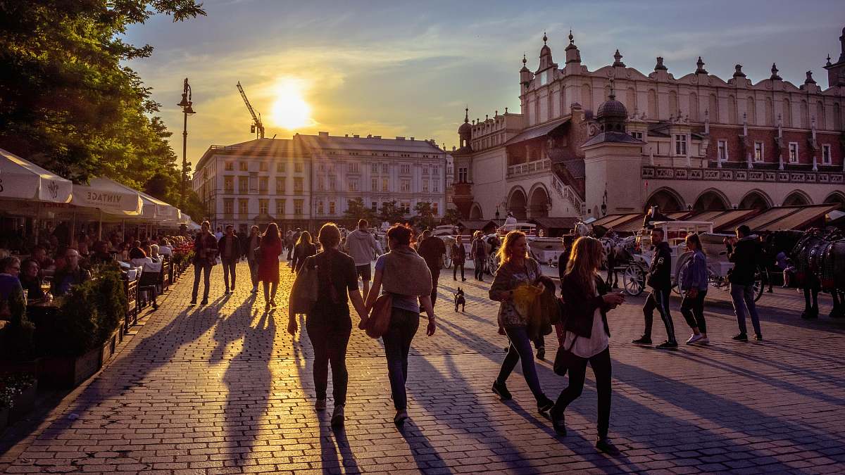 person people walking in front of Cloth Hall human