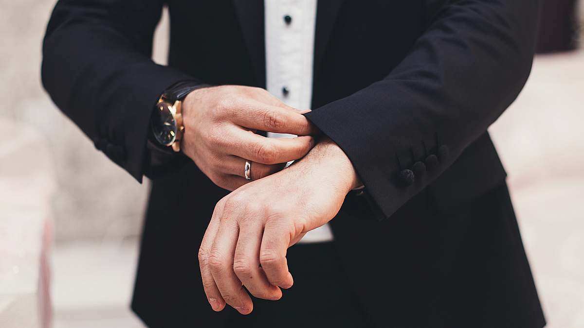 business A man's hands adjusting the cuffs of his black suit azerbaijan