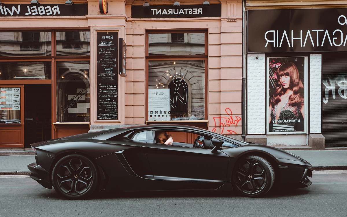 human black Lamborghini on the street person