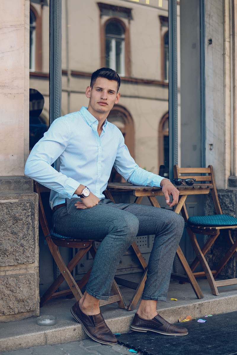human man sitting on chair near wall person