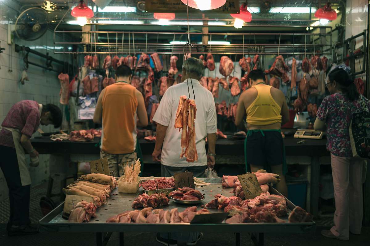 human raw meat display behind five person person