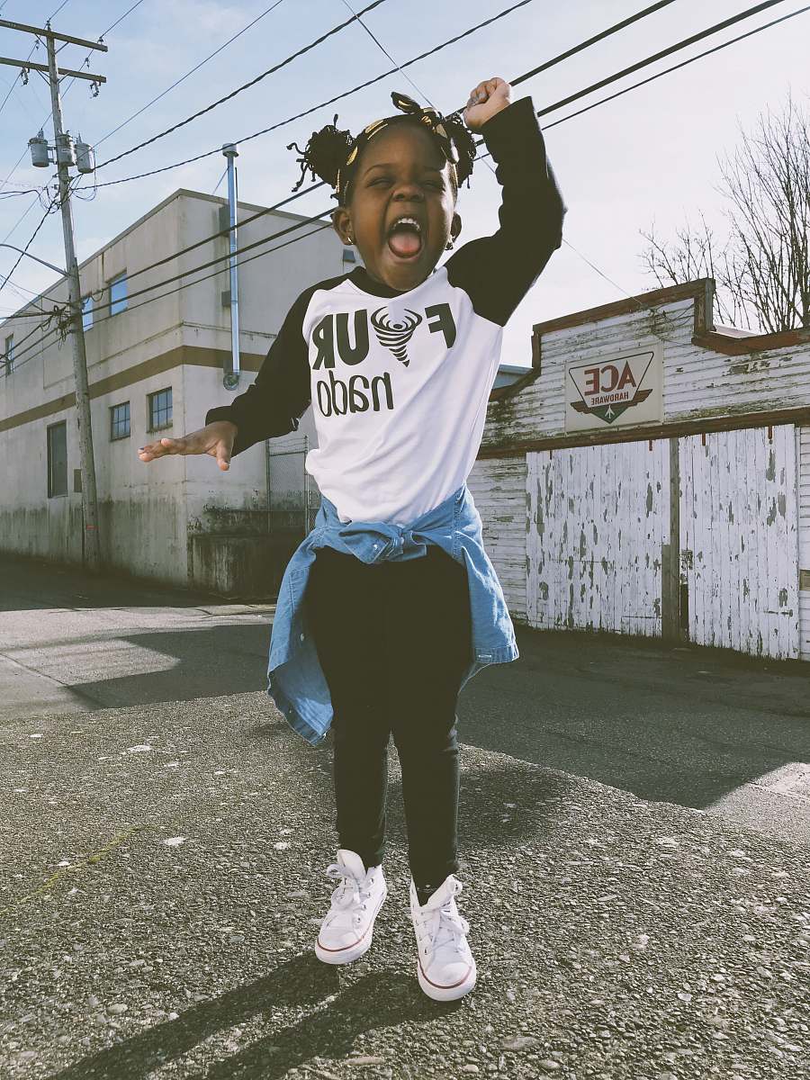 human girl stand near Ace storefront under cloudy sky during daytime people