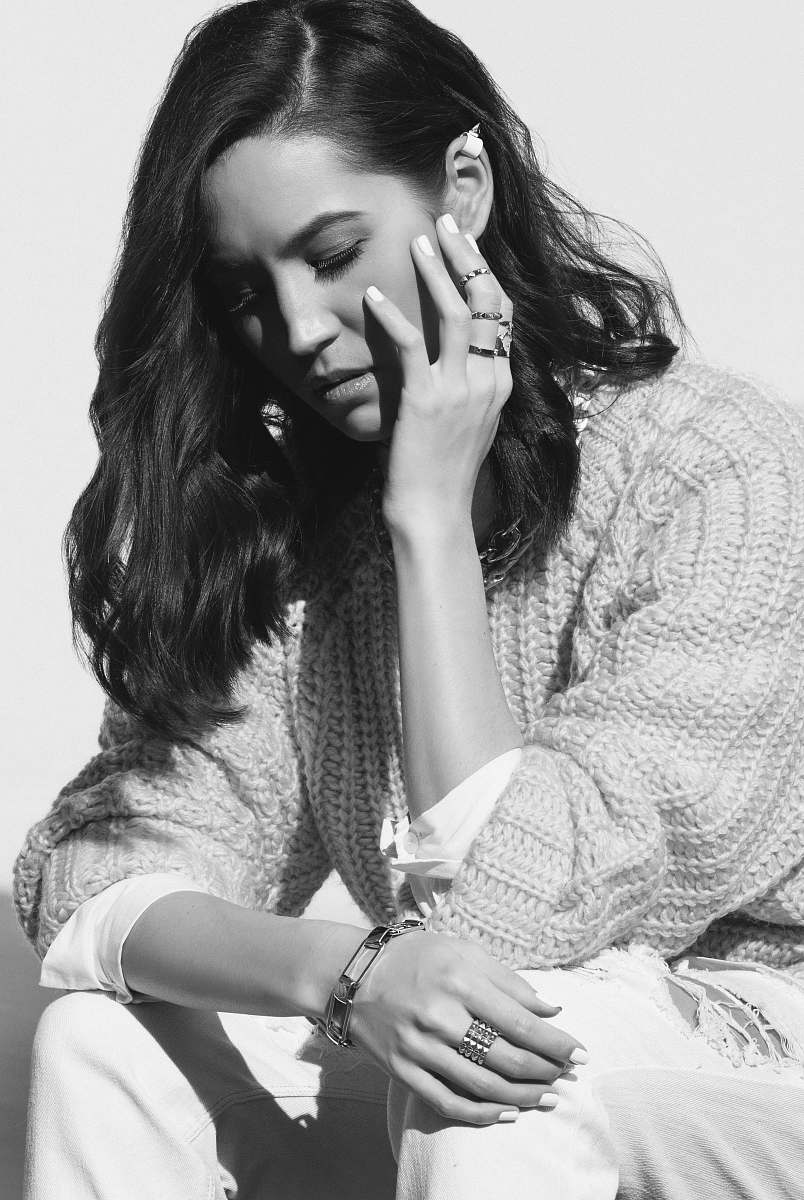 human grayscale photography of woman resting hands on knee black-and-white