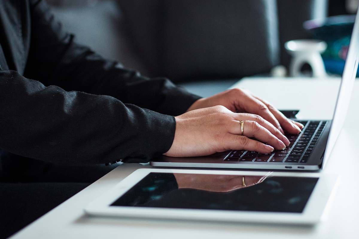 human man in black dress shirt using laptop electronics