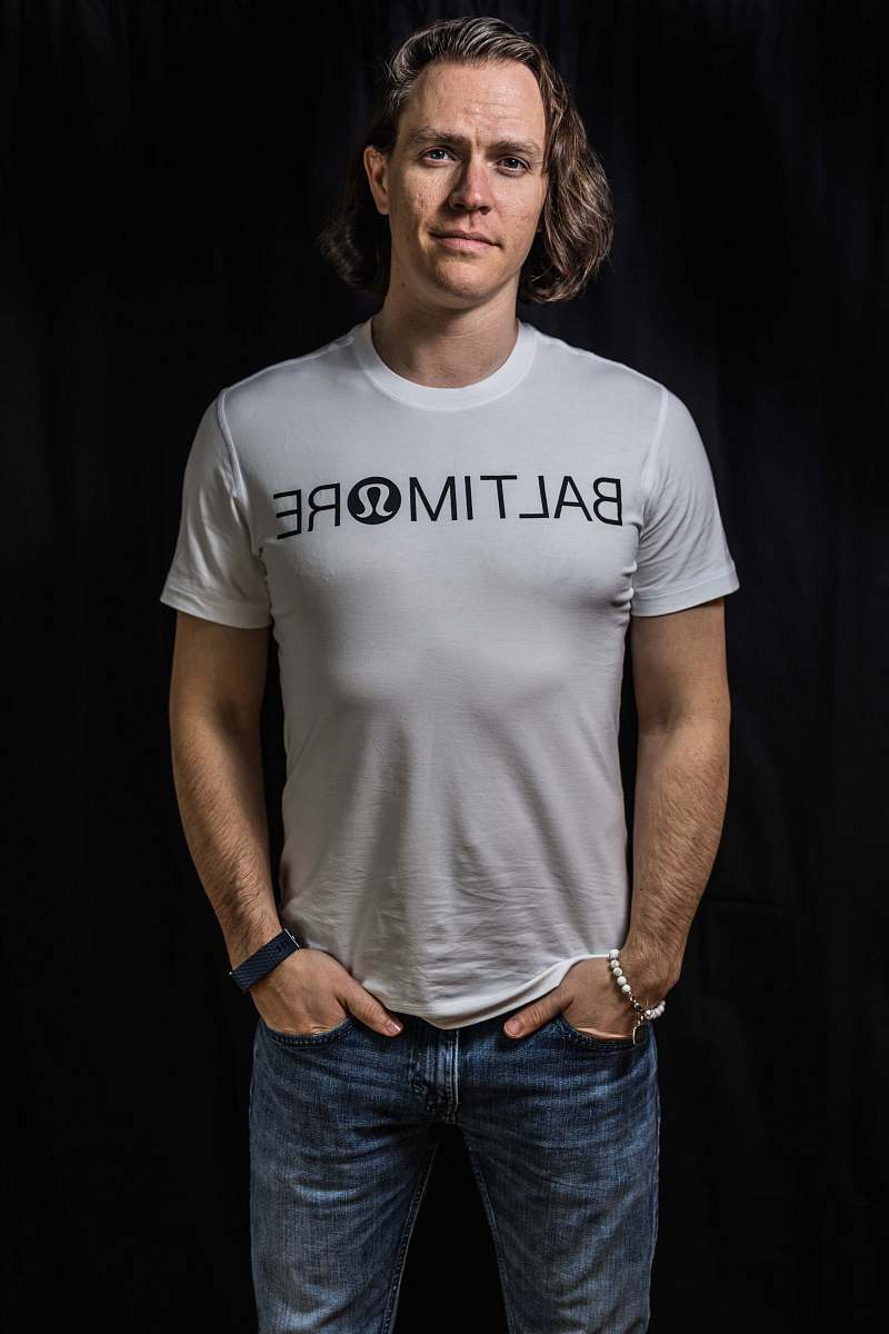 clothing man in white Baltimore t-shirt and blue jeans apparel