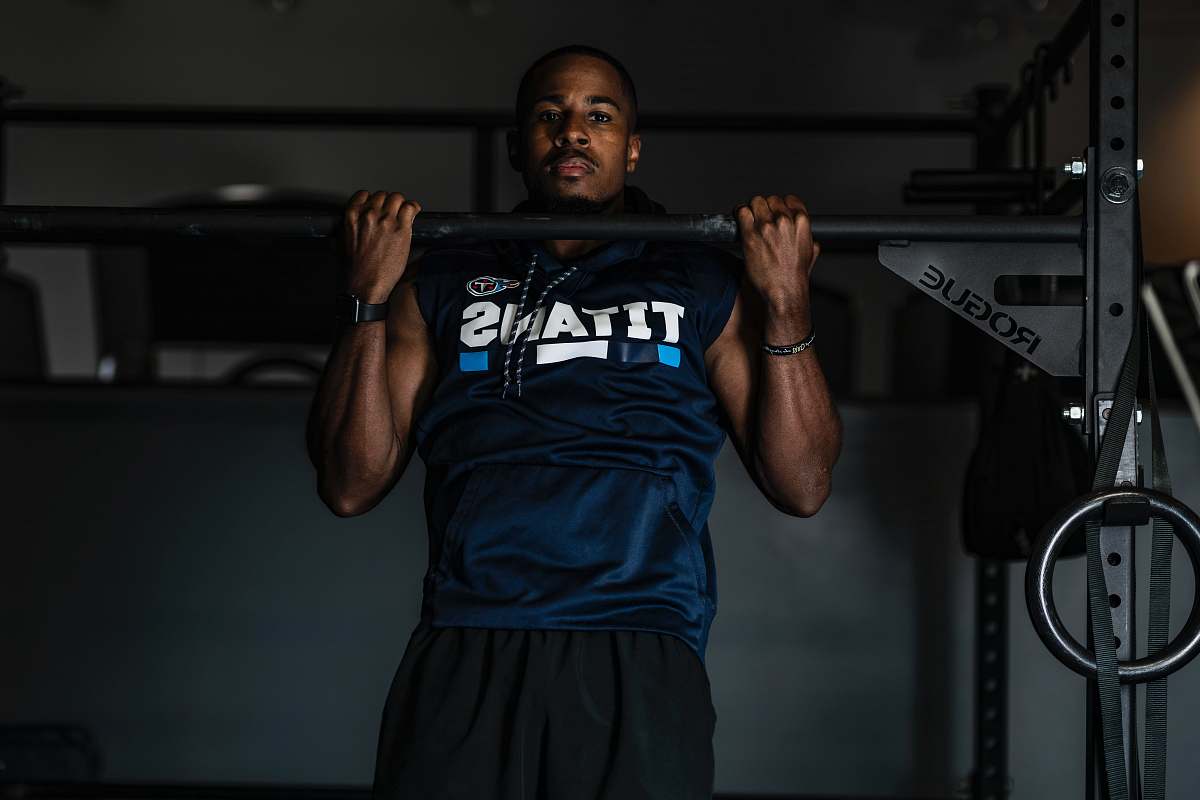 human man lifting up gym equipment working out