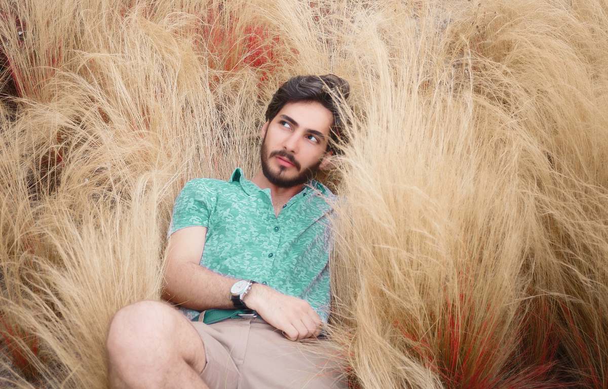 face man lying on brown grass human