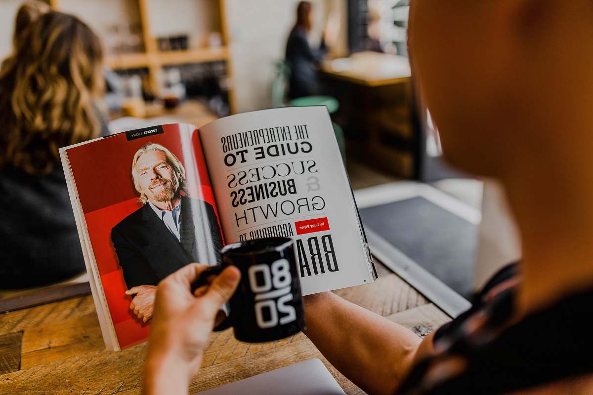 human man reading magazine book
