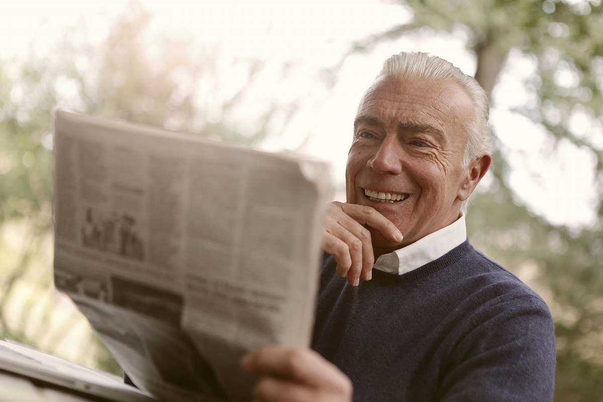 human man reading newspaper newspaper