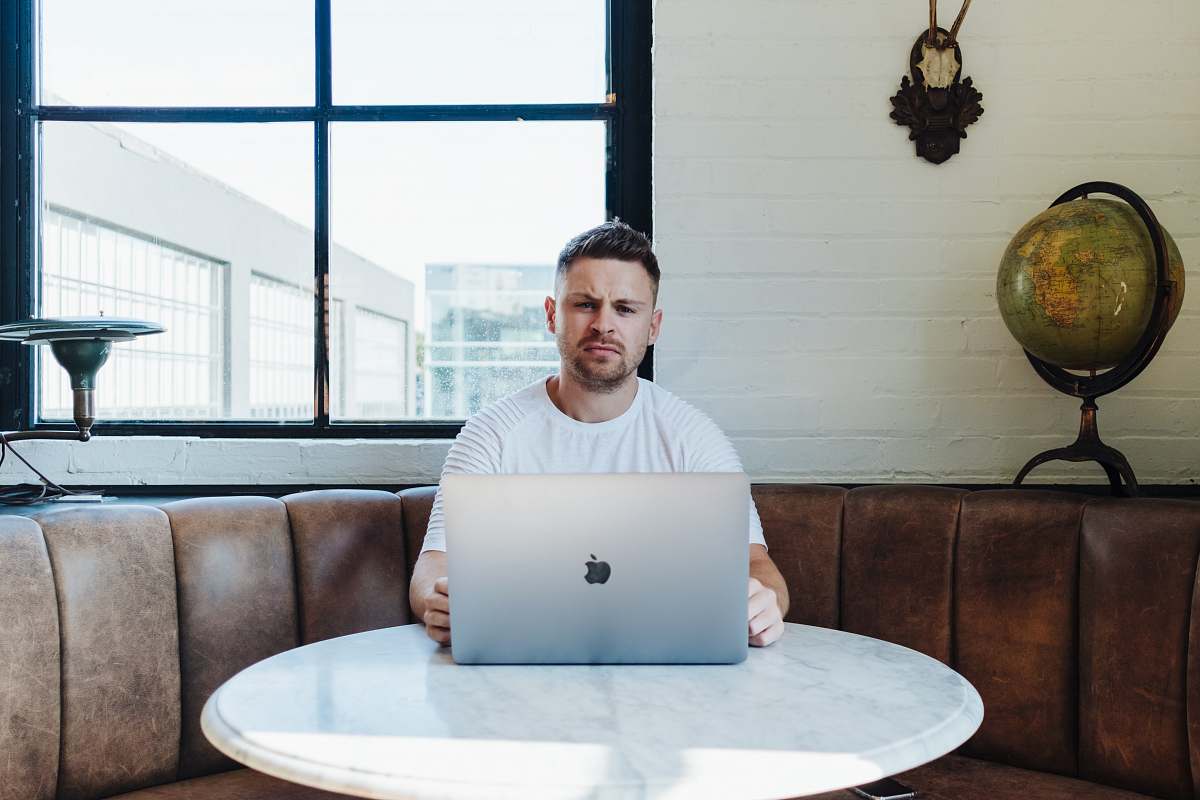 human man sitting infront of table furniture