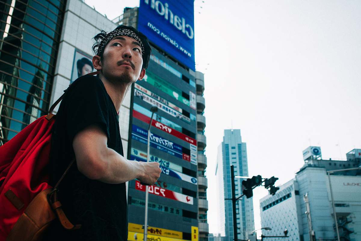 city man standing near buildings urban