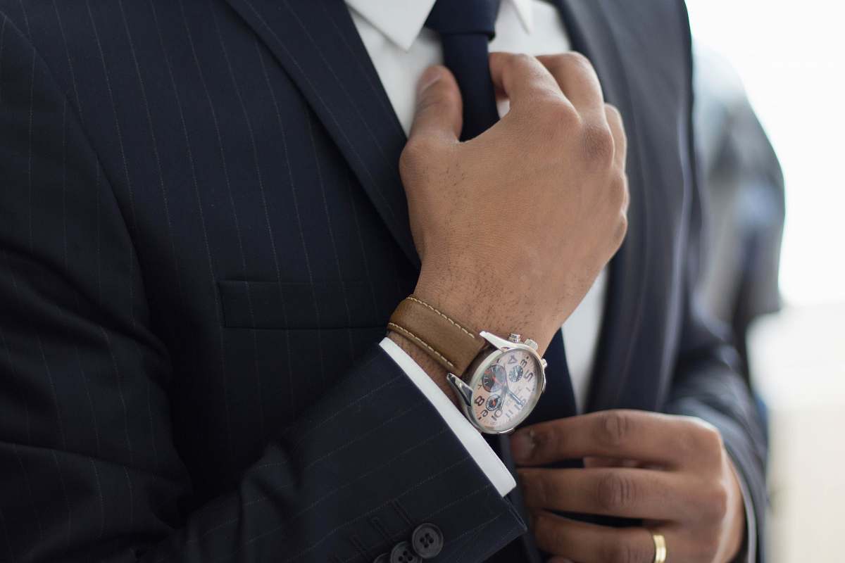 human man wearing watch with black suit people