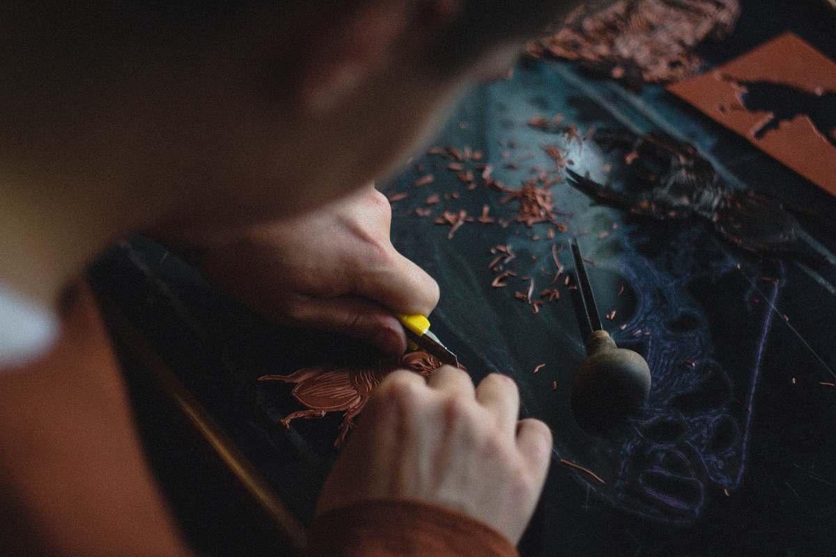 human person carving on black wood plank people