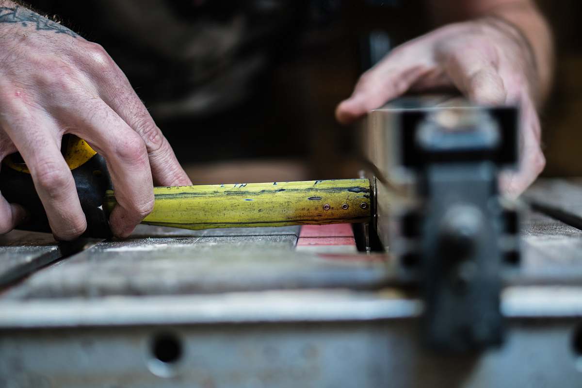 people person holding yellow steel measuring tape in closeup photo human