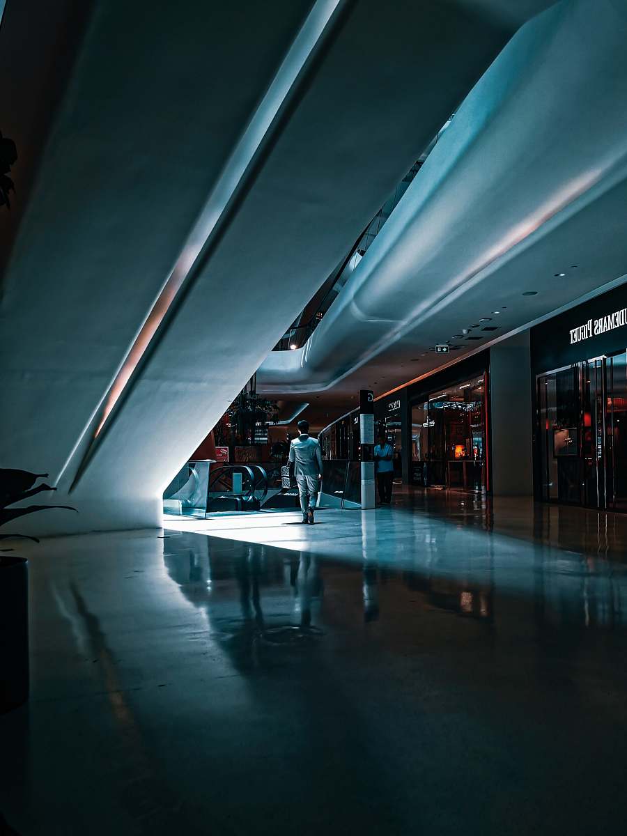human person walking beside escalator housing