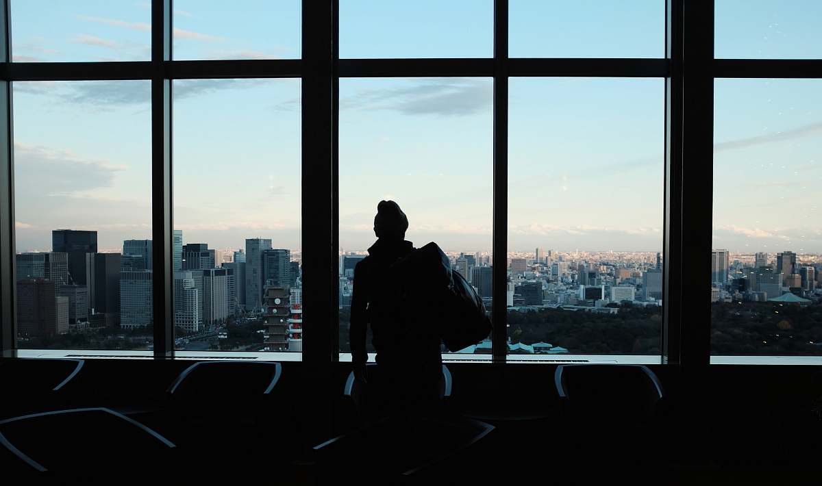 human silhouette of person looking to glass window silhouette