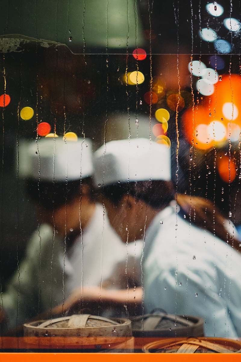 human two persons in white hats taken from glass frame with waterdrops people