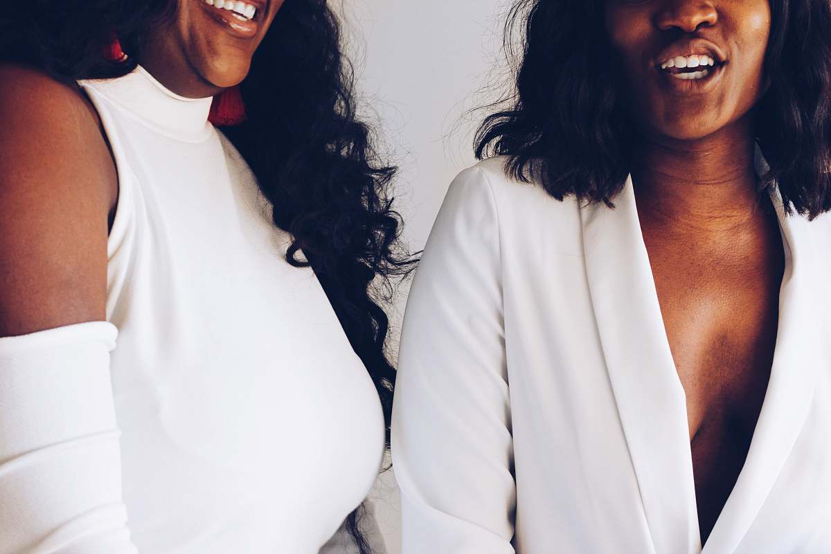 human two women wearing white tops face