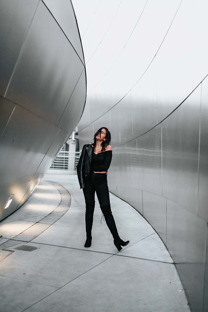 human woman in black off-shoulder dress and black pants people
