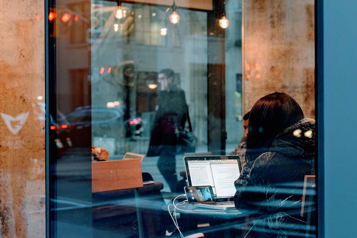 human woman inside a building using her laptop people