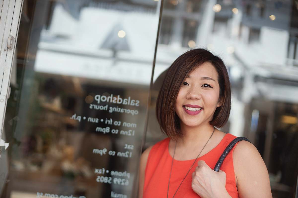 human woman leaning on glass wall panel happy teacher