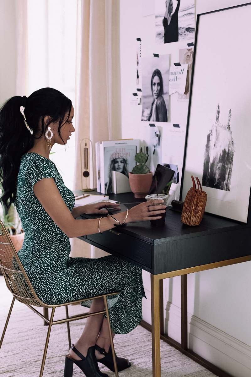 human woman sitting beside table inside room sitting