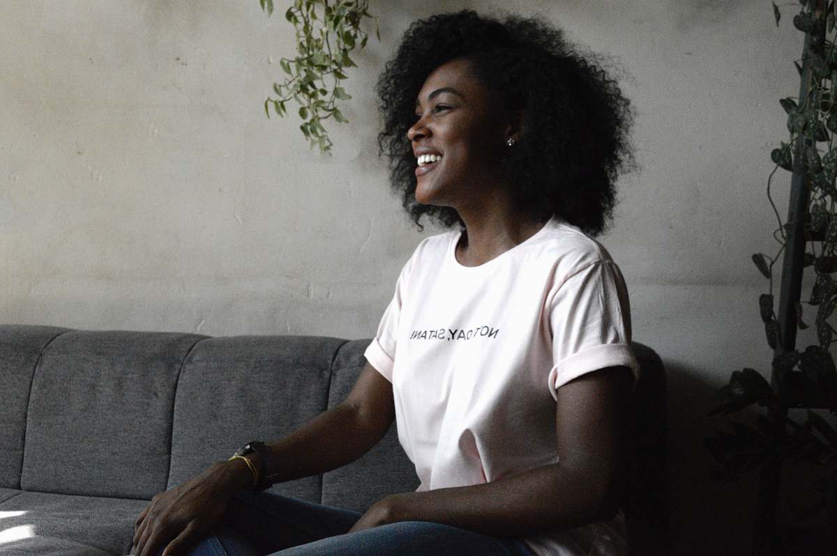 human woman smiling sitting on sofa hair